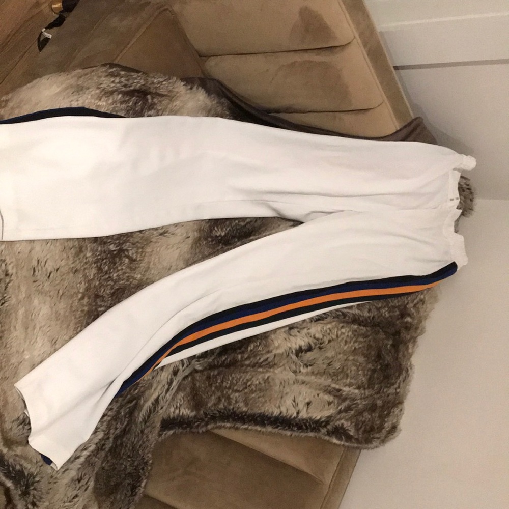 White pants w/ blue, black, yellow striped sides